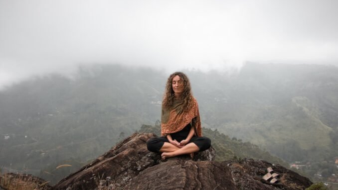 calm woman on mountain meditating