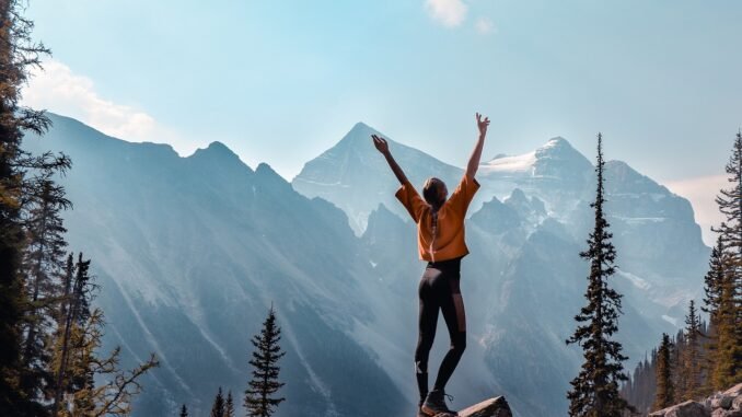 happy Lady on Mountain goal set achieve affirmation